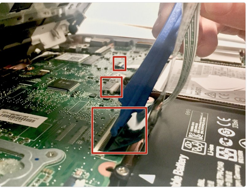 Image of a plastic opening tool prying off a rubber pad from the HP laptop.